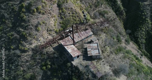 Aerial drone scene of Third Station of Cable Car Chilecito - La Mejicana gold mine. General view of construction, iron rails, wagons. Camera descending from senital. National industrial Heritage photo