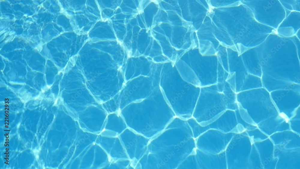 A beautiful view of swaying light bue waters in a pool with dazzling yellow lines shaping a jolly and optimistic background. A beautiful view of swaying light bue waters in a pool with dazzling yellow lines shaping a jolly and optimistic background.