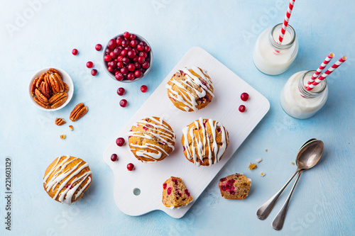 Muffins, cakes with cranberry and pecan nuts. Christmas decoration. Copy space. Top view.