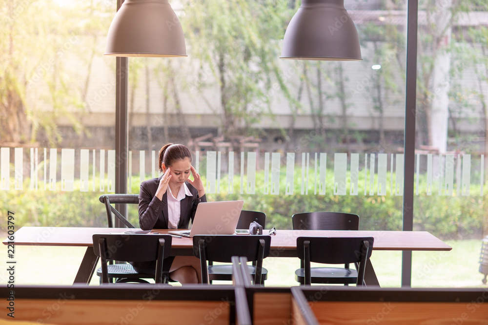 Ladies wear suit or Business woman is using laptop and she was stressed. Ladies wear suit or Business woman is using laptop and she was stressed.