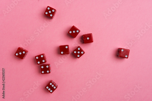 Red gaming dices on pink background. Flat lay, place for text. Game concept