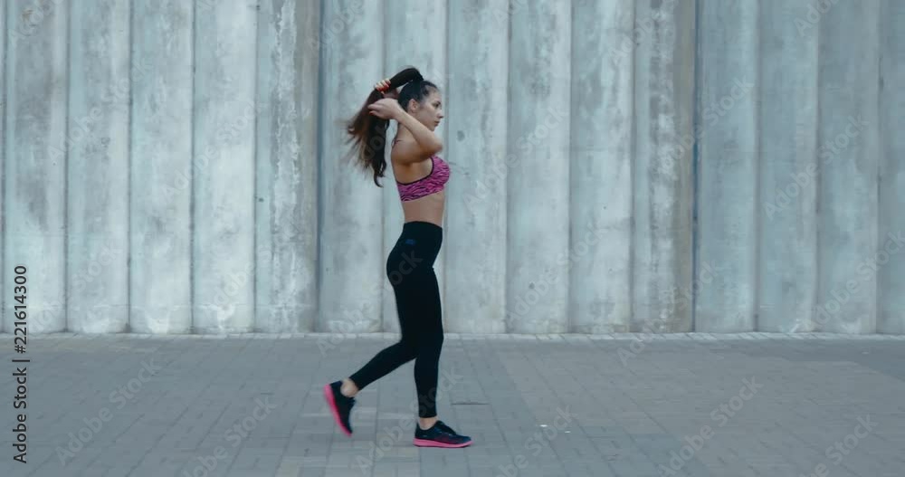 TRACKING Full length shot of fit young woman jogging in the street. Fitness model exercising in morning outdoors. Healthy lifestyle concept. 4K UHD TRACKING Full length shot of fit young woman jogging in the street. Fitness model exercising in morning outdoors. Healthy lifestyle concept. 4K UHD