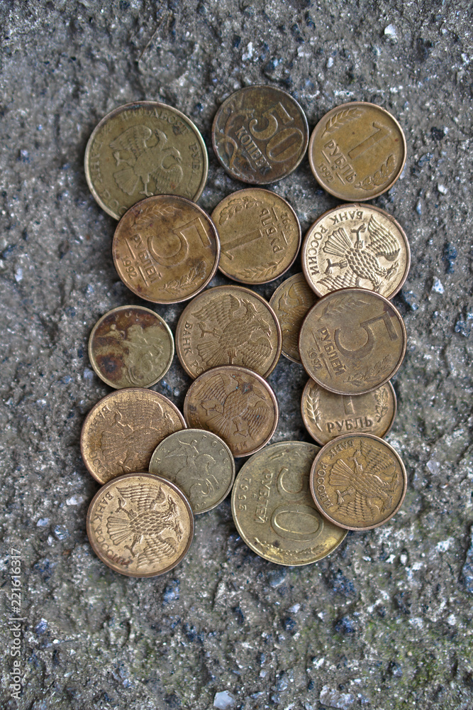 Russian coins on the background of concrete. set of coins for the numismatics of rubles. Coat of arms with two-headed eagle Russian coins on the background of concrete. set of coins for the numismatics of rubles. Coat of arms with two-headed eagle
