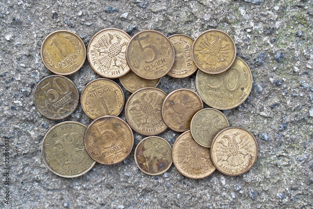 Russian coins on the background of concrete. set of coins for the numismatics of rubles. Coat of arms with two-headed eagle Russian coins on the background of concrete. set of coins for the numismatics of rubles. Coat of arms with two-headed eagle