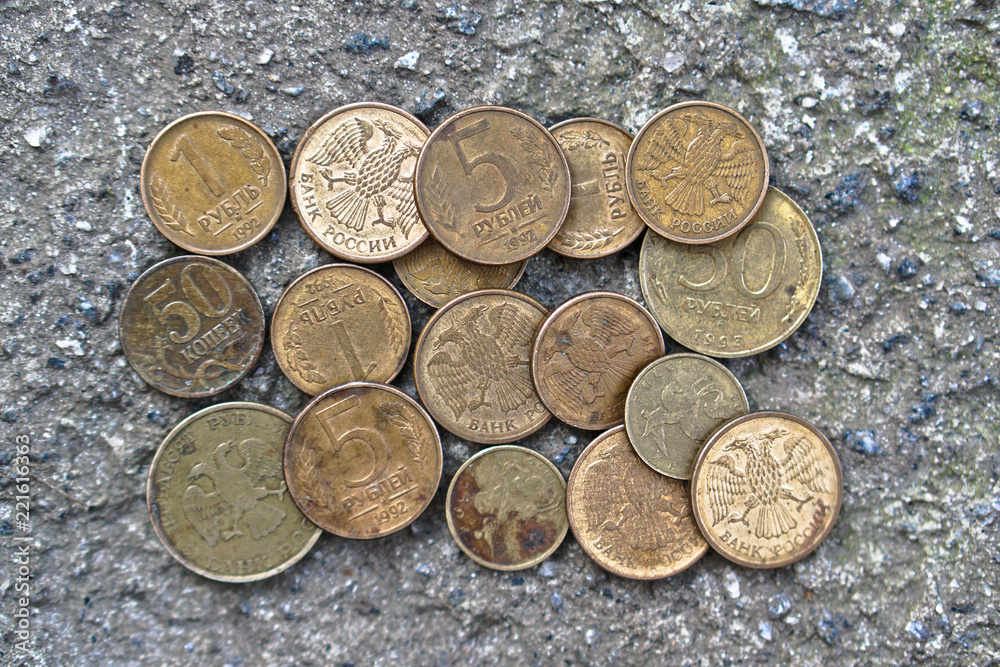 Russian coins on the background of concrete. set of coins for the numismatics of rubles. Coat of arms with two-headed eagle Russian coins on the background of concrete. set of coins for the numismatics of rubles. Coat of arms with two-headed eagle