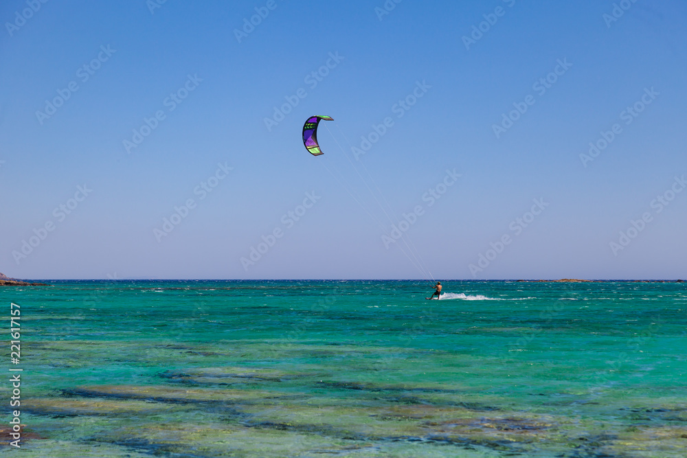 Kite surfer at famous Elafonisi beach in southern Crete, Greece. Kite surfer at famous Elafonisi beach in southern Crete, Greece.