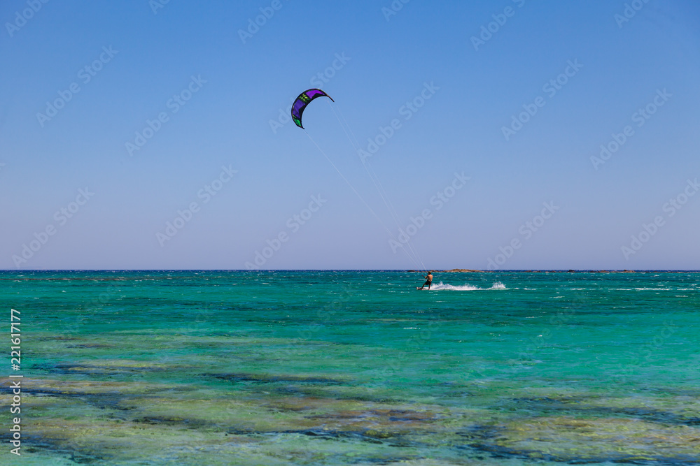 Kite surfer at famous Elafonisi beach in southern Crete, Greece. Kite surfer at famous Elafonisi beach in southern Crete, Greece.