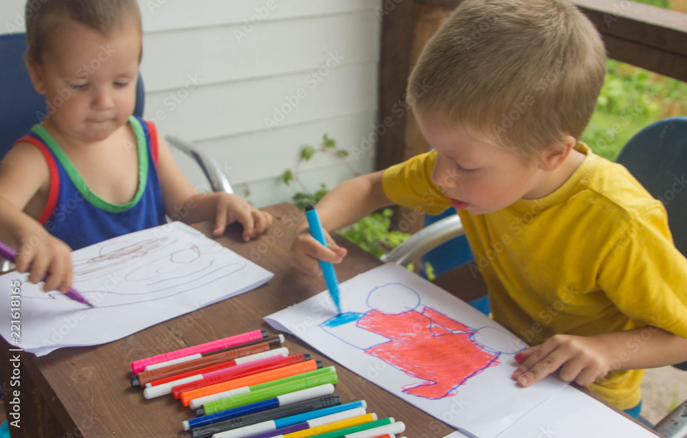 children draw with felt-tip pens, top view. boys draw colorful drawings. children draw with felt-tip pens, top view. boys draw colorful drawings.