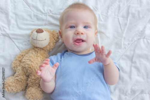 Baby and teddy bear. Cute baby with a soft toy.