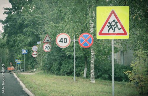 many road signs along the road. Traffic signs. Road signs.