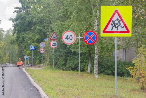 many road signs along the road. Traffic signs..