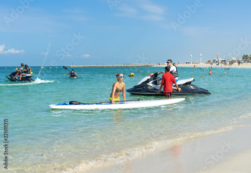 Photography Young woman carrying board at Kate beach in Dubai