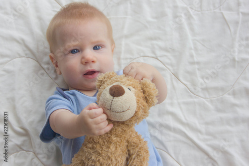The baby with keeps a teddy bear. A toy in the hands of a baby.