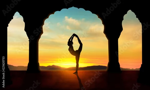Fototapeta woman in doing dancers yoga pose on temple