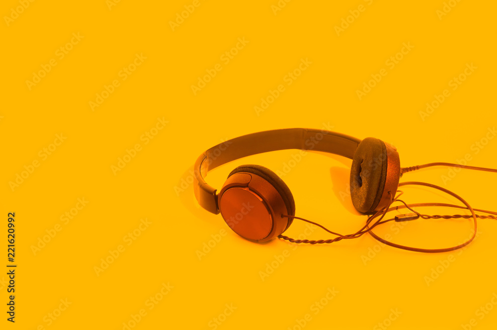 Headphones on orange background Headphones on orange background
