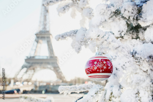 Eiffel tower and Christmas tree covered with snow in Paris photo