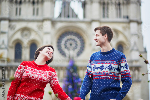 Couple on a street of Paris decorated for Christmas