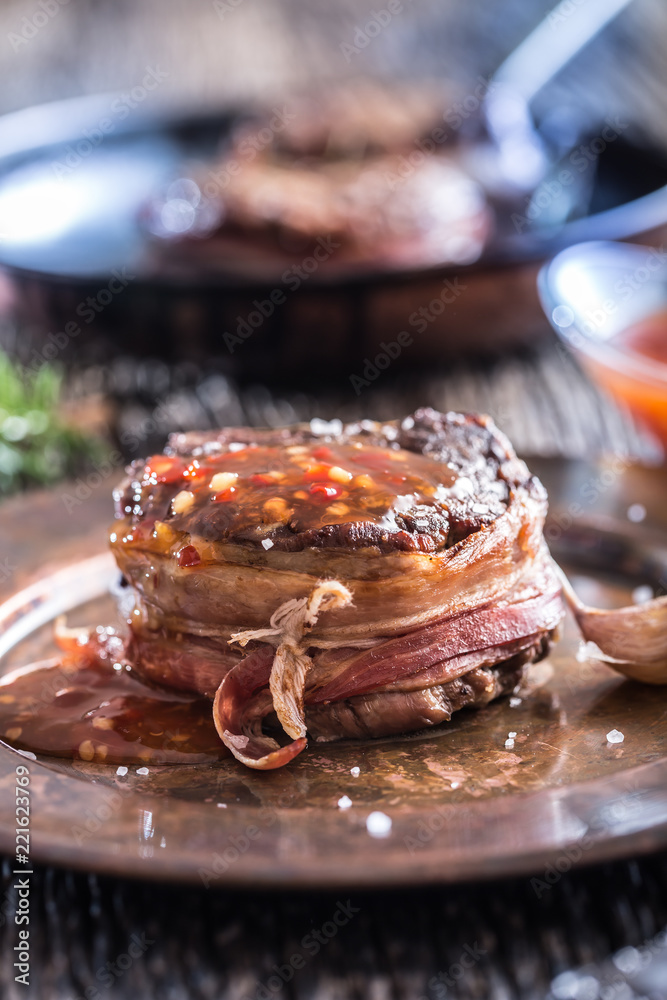 Grilled beef tenderloin steak with chili sauce in white plate