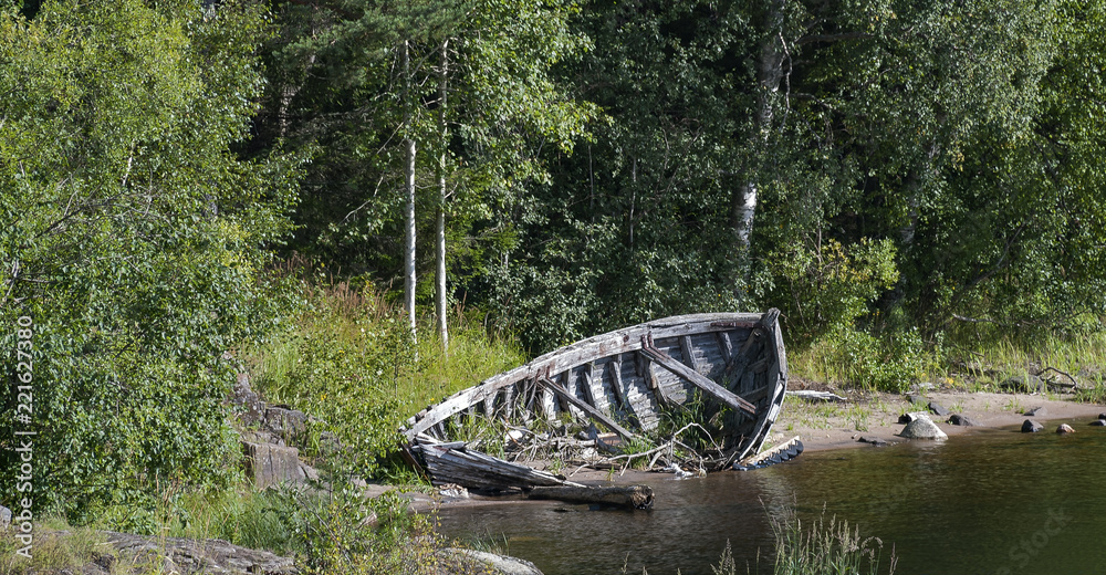 Old broken wooden boat on a river Old broken wooden boat on a river