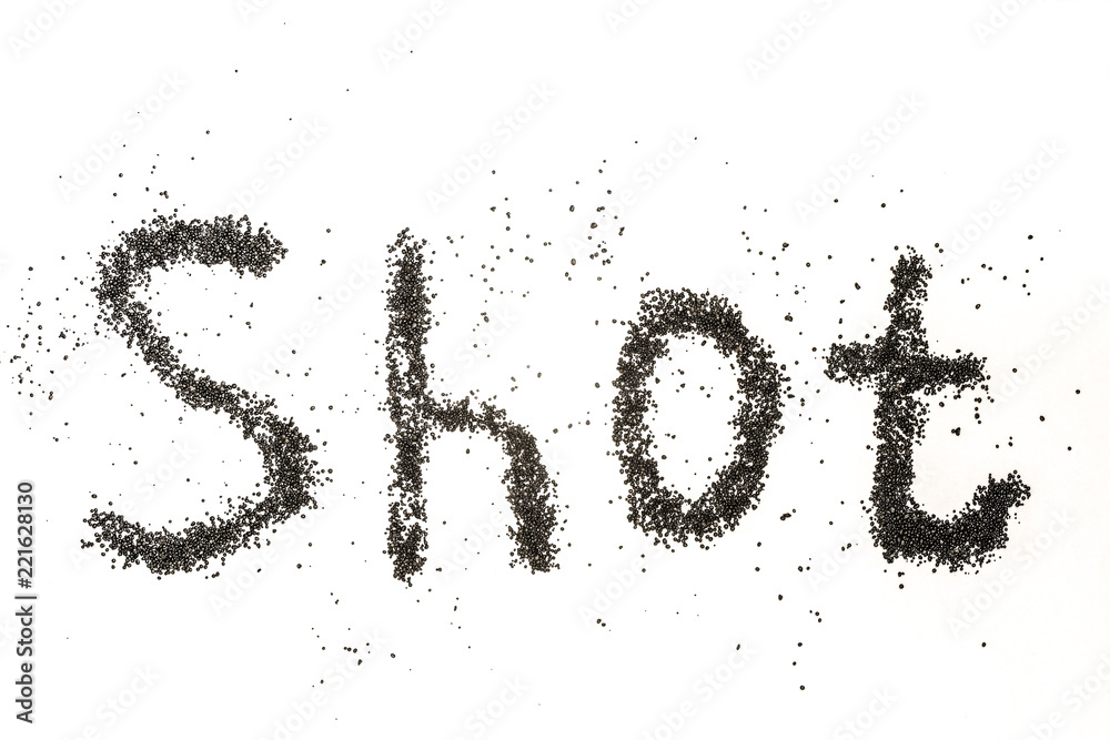 Steel shot for blasting machine. Inscription SHOT on a white surface with scattered small metal granules. Steel shot for blasting machine. Inscription SHOT on a white surface with scattered small metal granules.