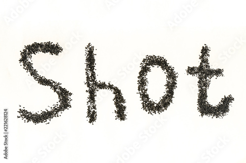 Steel shot for blasting machine. Inscription SHOT on a white surface.