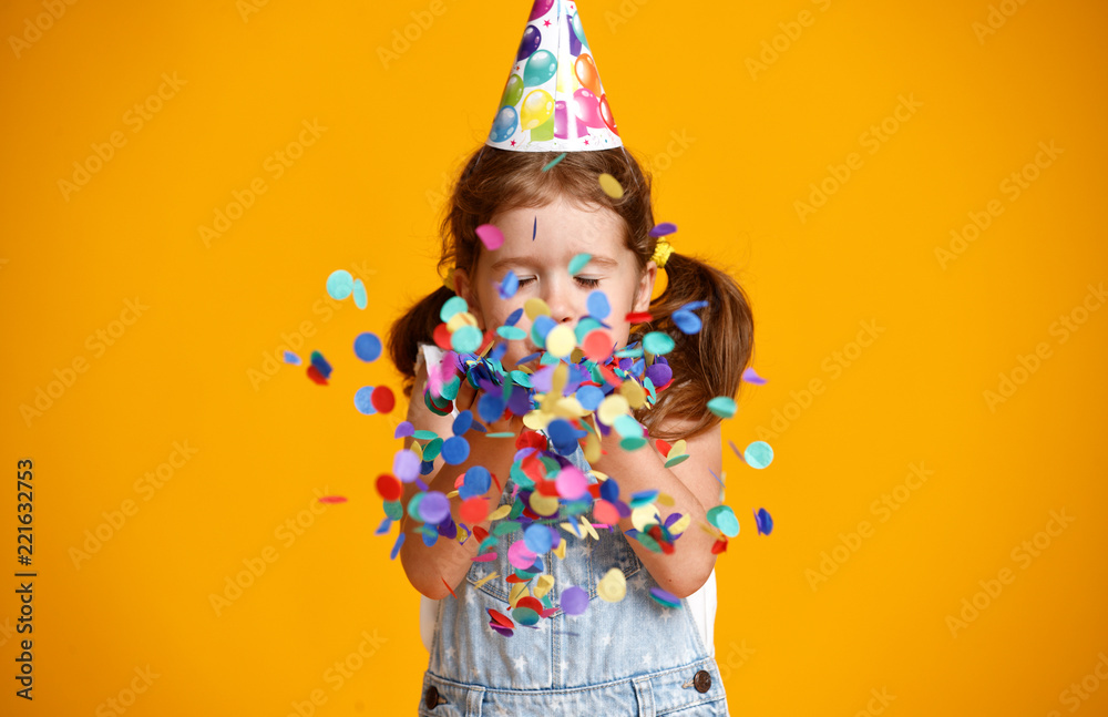 happy birthday child girl with confetti on yellow background - obrazy, fototapety, plakaty 
