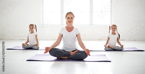  practicing engaged in gymnastics and yoga with  teacher photo