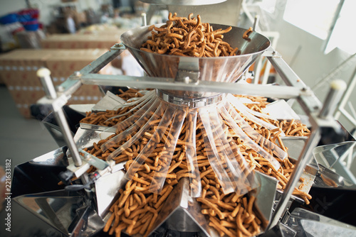 Closeup of salty snacks in food factor production line.