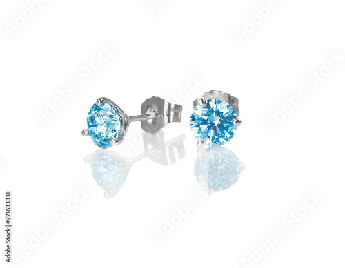 Fototapeta Naklejka Na Ścianę i Meble -  Blue diamond stud earrings topaz round brilliant isolated on white with a reflection