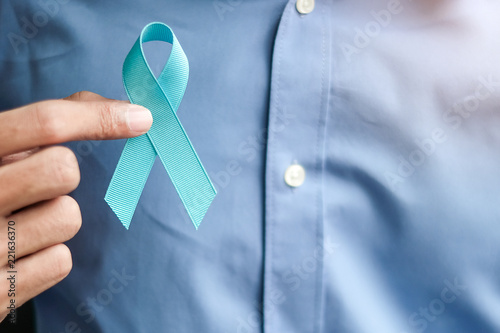 Prostate Cancer Awareness, Man holding light Blue Ribbon for supporting people living and illness. Men Healthcare and World cancer day concept photo