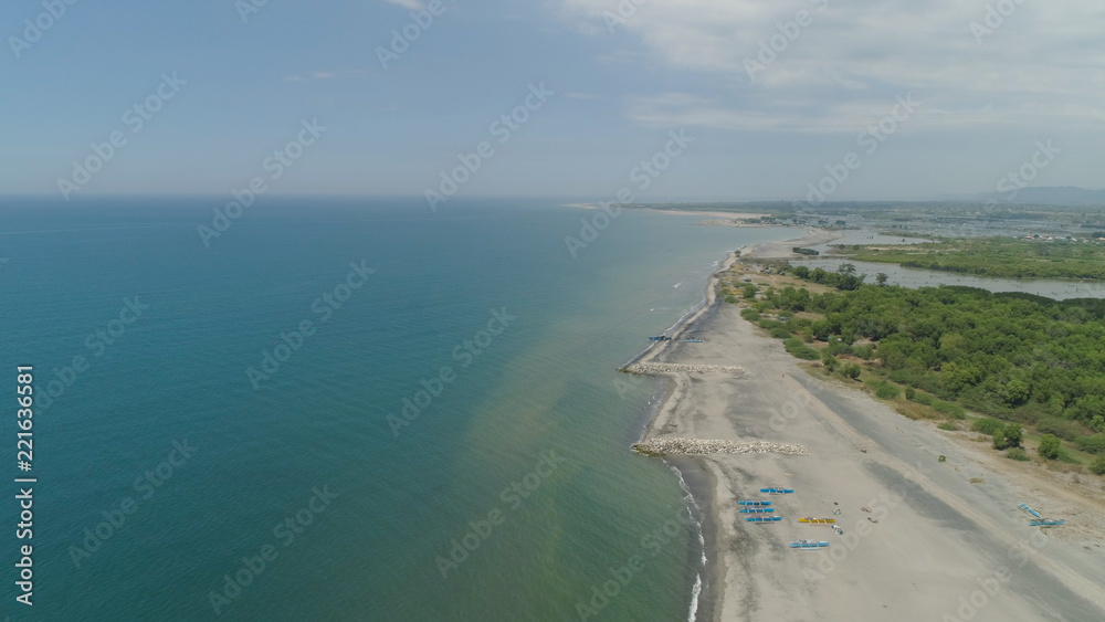 Aerial view of coastline with sandy beach, azure water on the island Luzon, Philippines. Seascape, ocean and beautiful beach. Agoo Damortis National Seashore Park.
