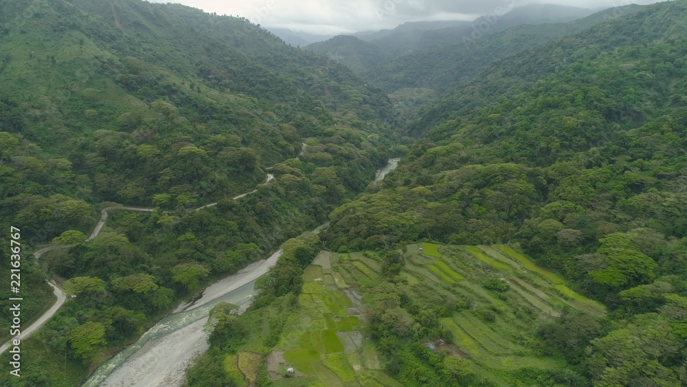 Aerial view of mountain valley in the cordillera, river, rice terraces, farmland in the Philippines, Luzon. Aerial view of mountains covered forest, tree. Cordillera region.
