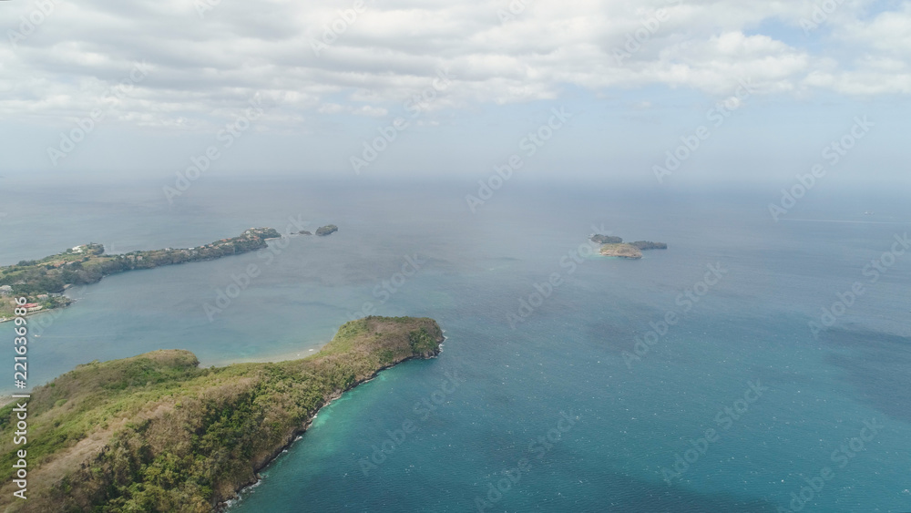 Aerial view of seashore with beach, lagoons and coral reefs. Philippines, Luzon. Ocean coastline with turquoise water. Tropical landscape in Asia.