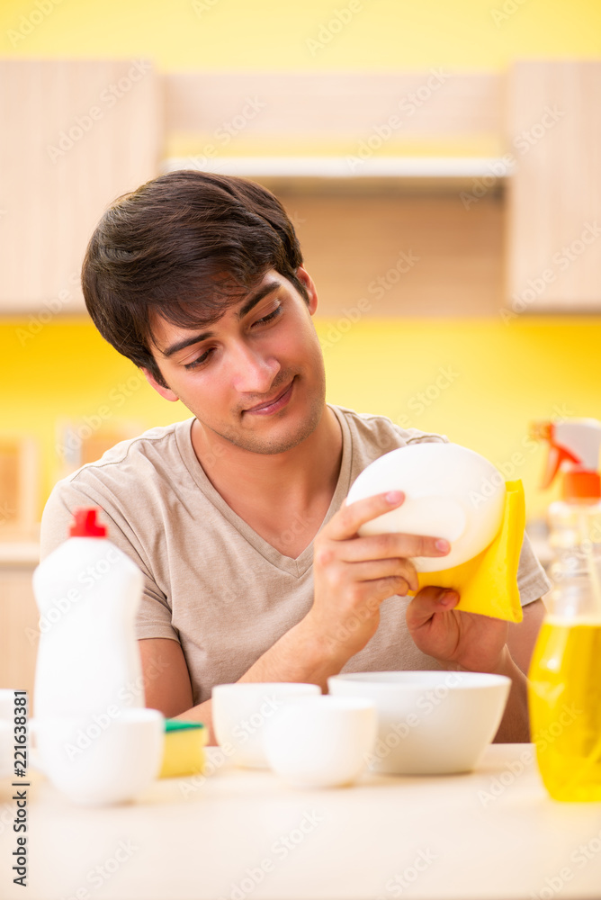 Man washing dishes at home