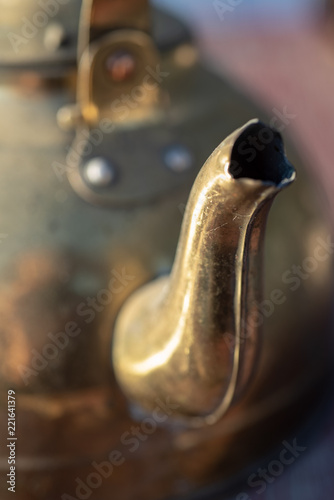 close up detail of vintage metal tea kettle pour spout photo