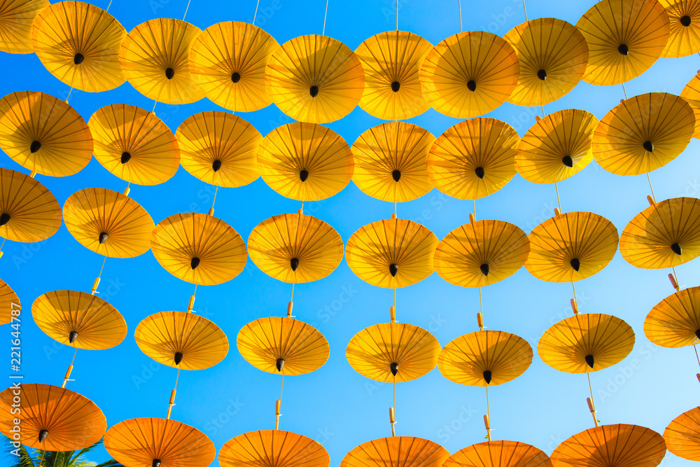 Naklejka premium Pattern Yellow umbrellas on blue sky.