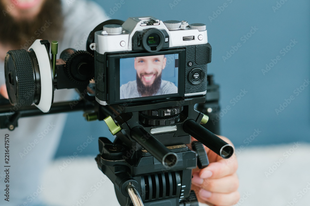 modern technology for photo and video shooting. camera on tripod. blogger equipment and tools. image of a man on screen. modern technology for photo and video shooting. camera on tripod. blogger equipment and tools. image of a man on screen.