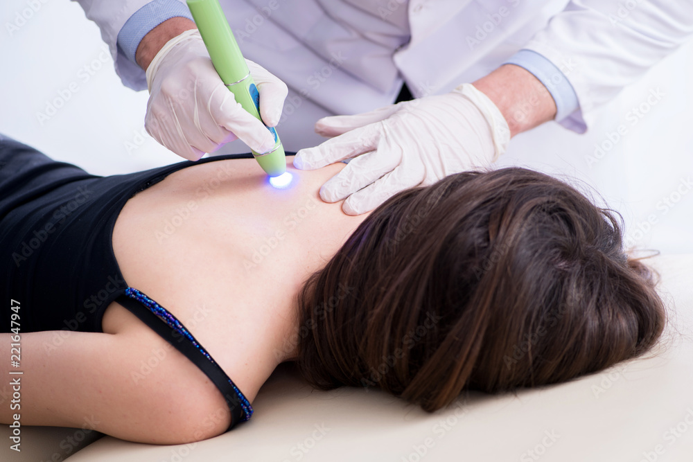 Patient in clinic undergoing laser scar removal