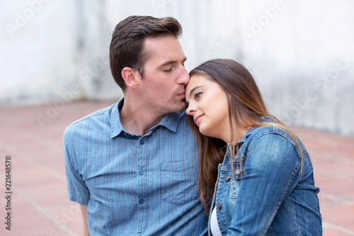 Beautiful young couple in love sitting down man kissing her forehead © Duvy   McGirr