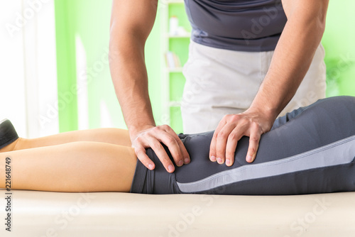 Young doctor chiropractor massaging patient 