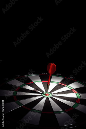 Target with arrow in the center on a black background
