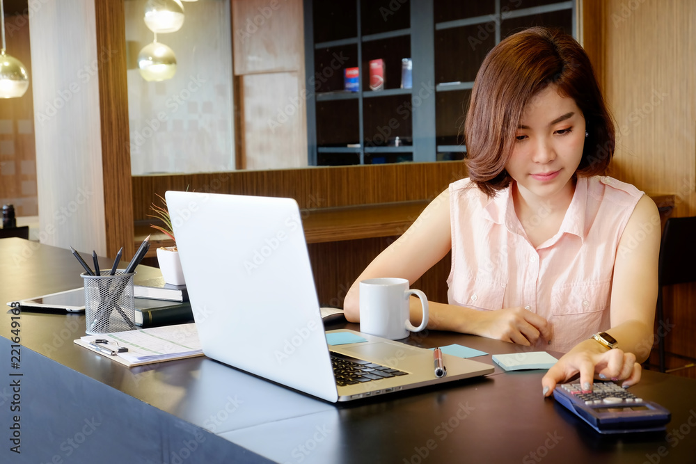 Business woman calculate finance data with calculator and laptop computer analysis financial. Business woman calculate finance data with calculator and laptop computer analysis financial.