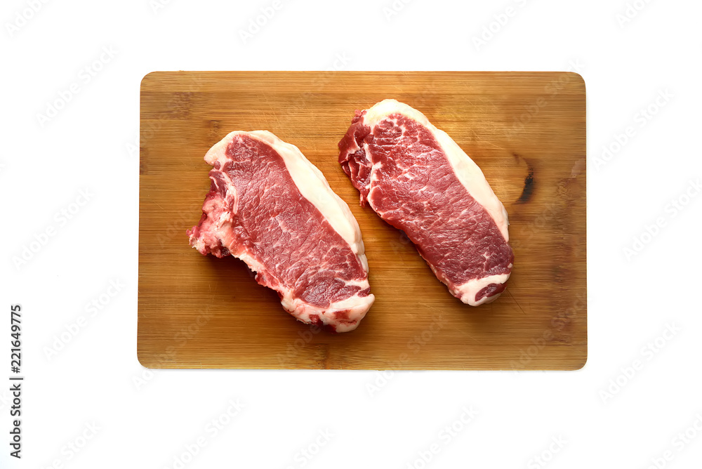 A fresh raw  marble beef on a cutting board on a white background.Top view.
