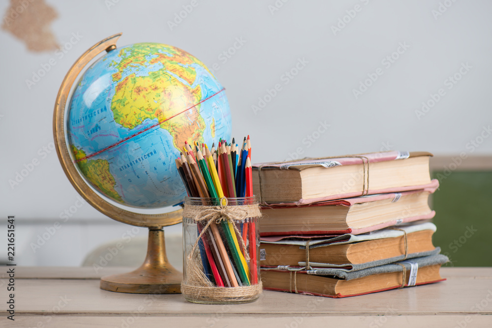 School background, books, globe and color pencils are on the desk Stock  Photo | Adobe Stock