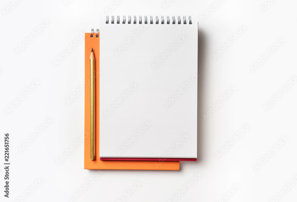 Top view of orange spiral notebook and pencil Top view of orange spiral notebook and pencil