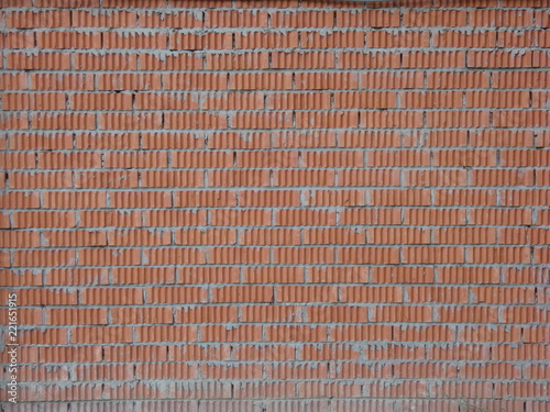 Wall of relief orange bricks