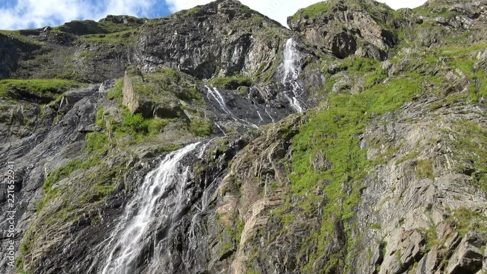 View waterfall scenes in mountains, national park Dombai, Caucasus, Russia. Summer landscape, sunshine weather and sunny day View waterfall scenes in mountains, national park Dombai, Caucasus, Russia. Summer landscape, sunshine weather and sunny day
