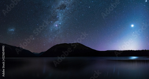 Panorama, Amanzing Starry night at Lake Rotoiti. Reflection of the Milky way and galaxy on the lake. Nelson Lake National Park, New Zealand. High ISO Photography.