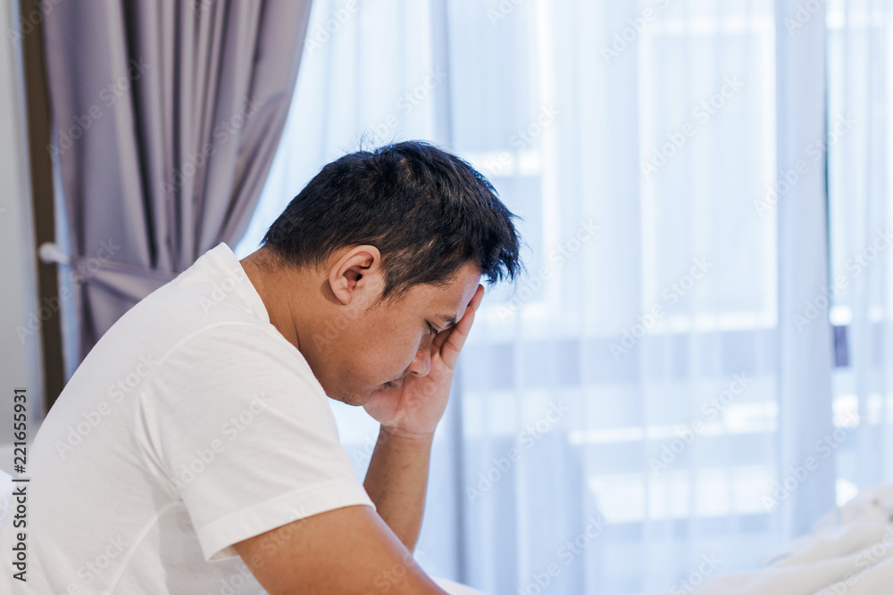 Man in bed with headache after wake up. Man in bed with headache after wake up.