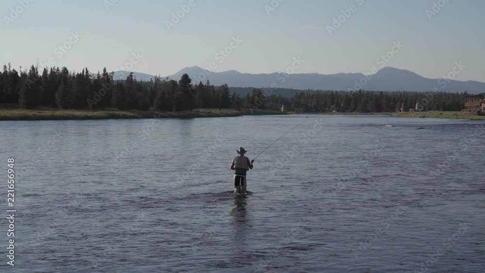 Fly fisherman fishing in Henrys Fork river, slow motion Fly fisherman fishing in Henrys Fork river, slow motion